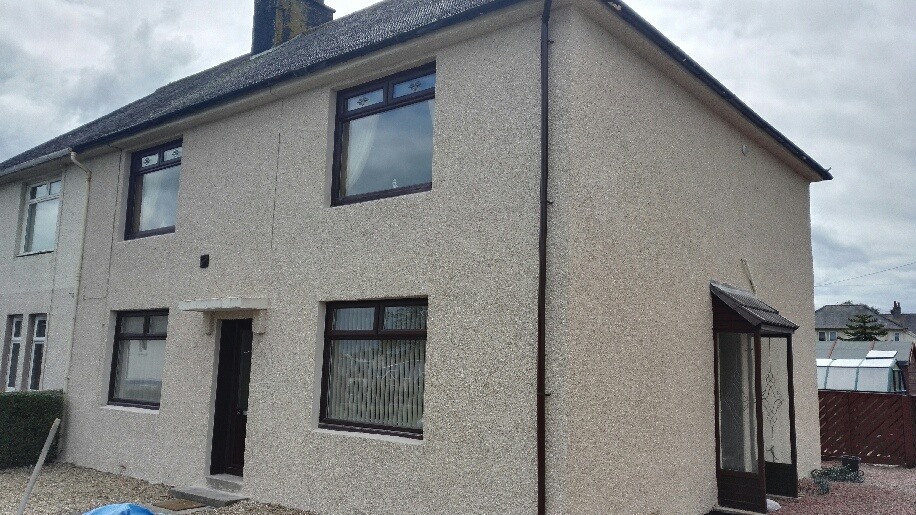 Semi-detached house with a roughcast exterior finish